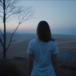 a young woman looking out into the horizon