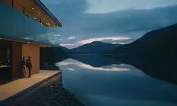 two people are looking out onto the mountains at night