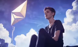 a woman is sitting down next to a kite