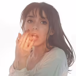 an attractive young woman blowing her nose and hand
