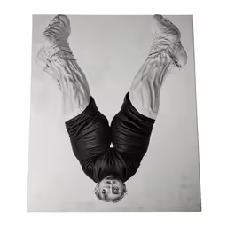 a black and white photo of a person upside down