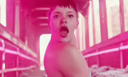 an image of a shirtless young boy making a face