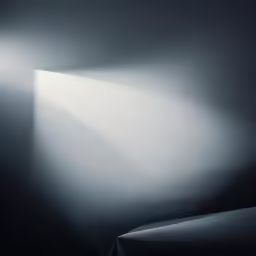 an empty room with a light on the wall