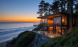 a house overlooking a beautiful sea with its lights on