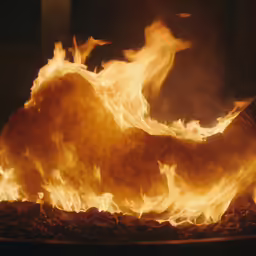 fire and rock with a large black plate full of coal