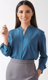 a woman in a blouse and slacks smiling