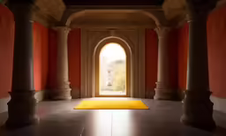 bright yellow carpet on stone flooring next to arches and doorways