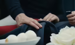 a person with their hands on a bag