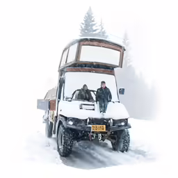 two men standing on a ski truck and in the snow