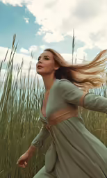 a woman in a dress is walking through some tall grass