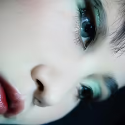 a closeup shot of a childs face with blue eyes