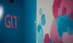 the letters glit painted on the wall are red, blue, and white