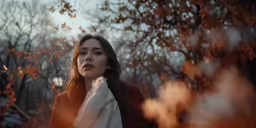 a woman in a coat looking up at the sky