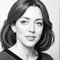 a woman wearing a sweater and statement earrings posing for a picture
