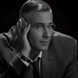 man talking on phone with black background