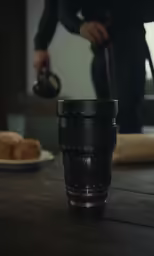 a coffee cup sitting on top of a wooden table