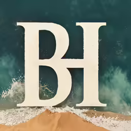 a block letter is standing out against the backdrop of the beach