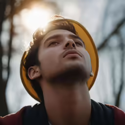 a man standing in a forest looking up