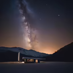 a house that is near a mountain in the snow