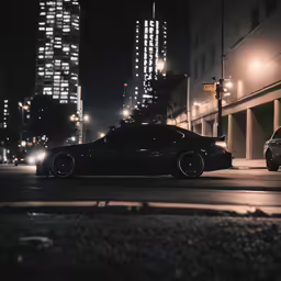 a black car sits parked near another car on the street