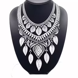 a black mannequin with a white and grey statement necklace,a necklace is displayed on a black display stand