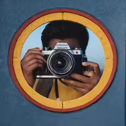 a man with a camera taking a picture through a circle