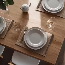 the table is set with a wooden table cloth