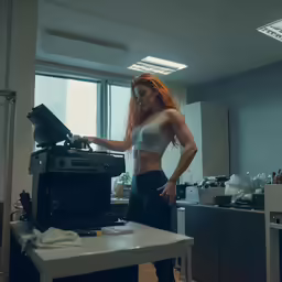 there is a woman working with a laptop computer