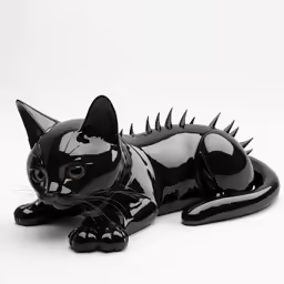 a black cat figurine is laying on the floor