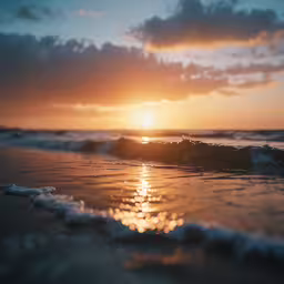 water lapping on the beach at sunset