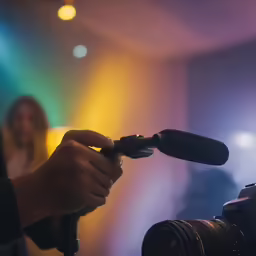 a man taking pictures and recording in front of microphone