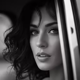 the woman looks out of a car window