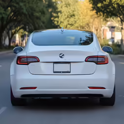 the back of a car driving down a street