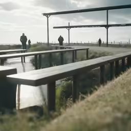 a group of benches sitting in front of a sandy beach
