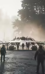 a group of men and women walking down a wet road