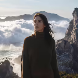 there is a woman that is standing on a mountain