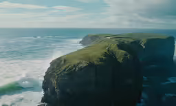 a view of a rocky cliff with an ocean view