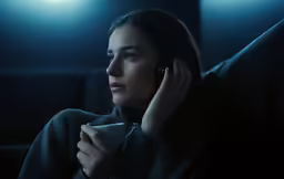 the girl is using her phone while talking on a cell phone