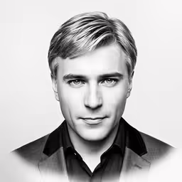 man in black and white photo wearing a jacket