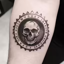 a tattoo with a skull and inscription on it
