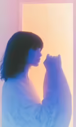 the silhouette of a woman with a cat in front of her