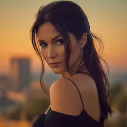 a beautiful young woman standing in front of the city