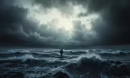 a surfer standing on top of the ocean at night