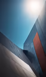 a building with red and gray panels under the sun