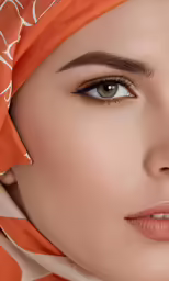 the face and lip of a woman wearing an orange scarf