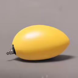 a plastic yellow banana sitting on top of a table