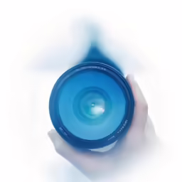 a hand holding a blue camera lens on top of white background