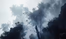 a cloudy sky with some clouds and trees in it