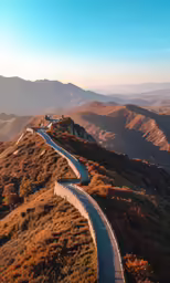 an aerial view of the road below, passing the hills