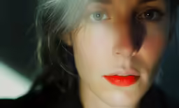 the woman with red lips looks straight ahead